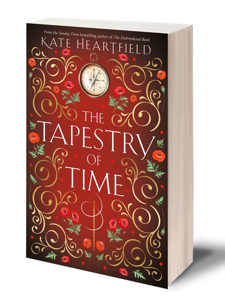 The paperback of The Tapestry of Time, cover designed by Toby James. It is deep red with poppies, a compass and a needle and thread.